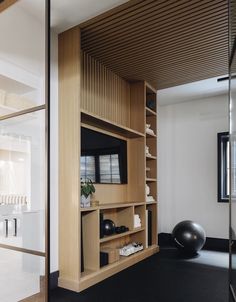 a living room with a television and exercise balls