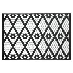 a black and white door mat with hexagonal designs