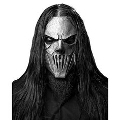 a man with long hair wearing a mask