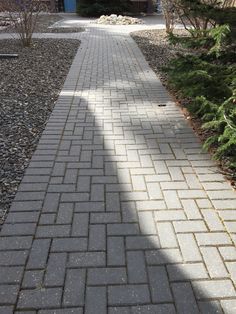 a brick walkway in front of a house