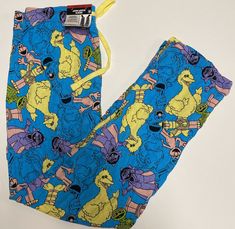 Elevate your pajama game with these Men's Sesame Street Sleep Lounge Pajama Pants. Featuring your favorite Sesame Street characters including Big Bird, Oscar, Elmo, and Count, these lightweight pants are perfect for year-round wear. Made with 100% cotton jersey fabric, these pajama pants are comfortable and breathable, making them ideal for a good night's sleep. These Sesame Street pajama pants come in a size small and are designed for men. The blue color and bird theme add a fun touch to your sleepwear. These pajama pants are brand new with tags and are a great addition to any Sesame Street fan's collection. Best Pjs, Lego City Police, Sesame Street Characters, Oscar The Grouch, Street Brands, Bird Theme, Lounge Pajamas, Bird Pattern, Lightweight Pants