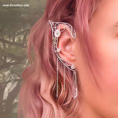 **Embrace the ethereal allure of elven grace with these enchanting Elven Bride Elf Ears by Elven Rose.** Crafted with love and meticulous attention to detail, these silver and white earrings embody the grace and allure of the elven realm. The delicate curves mimic the elegant shape of elven ears, while the intricate details capture the essence of elvish craftsmanship. Each earring delicately wraps around the earlobe, creating an enchanting and mystical aura. **Highlights - Handcrafted Excellence: Each pair is meticulously handcrafted using high-quality materials, ensuring both durability and exquisite craftsmanship. - Premium Materials: Made with non-tarnish silver-plated wire, Swarovski crystals, resin flowers, and Moonstone. - Fantasy-Inspired Design: The gleaming silver finish complemen Elven Jewelry Earrings, Fairy Wedding Jewelry, Elfish Wedding, Elves Jewelry, Elven Bride, Elf Ear Jewelry, Moth Girl, Elven Ears, Elvish Wedding