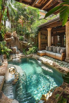 an outdoor pool with waterfall and seating area next to it, surrounded by greenery