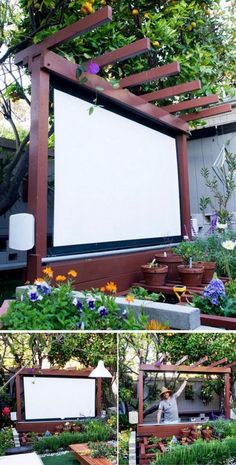 an outdoor movie screen surrounded by plants and flowers