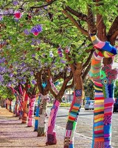 the trees are decorated with colorful yarns