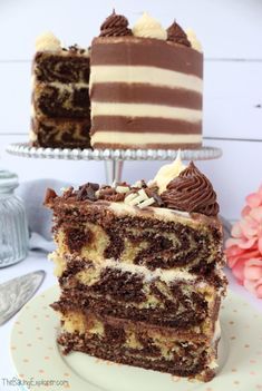 two pieces of chocolate cake sitting on top of a white plate next to each other