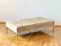 a bench sitting on top of a hard wood floor