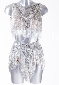 a white mannequin with silver sequins on it's chest and back