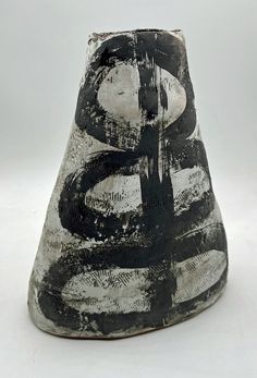 a black and white vase sitting on top of a table