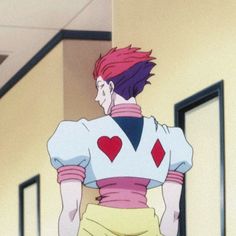 an anime character with pink hair and heart - shaped patches on his shirt is walking down the hallway