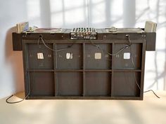 an old record player is sitting on top of a shelf with several records and tape recorders attached to it