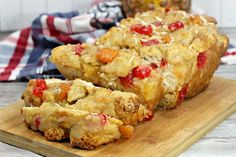 two slices of fruit bread on a cutting board with a red and white checkered napkin