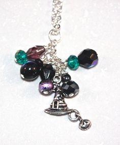 A friend of mine really liked my bridesmaid pearl necklace sets, and really wanted one just for her. That prompted me to make a few to share with everyone.  This dangle charm necklace is handcrafted by me. I make each dangle charm and really take time to try and make each one special. This necklace is a fun way to bring out your witchy side. It has lovely shades of purple, green, and a touch of black. It is made with a nickel free zinc alloy witch hat with a dangle jack-o-lantern. There are also Bridesmaid Pearl Necklace, Bridesmaid Pearls, Pearl Necklace Set, Necklace Sets, Dangle Charms, Green And Black, Witch Hat, Halloween Witch, Shades Of Purple