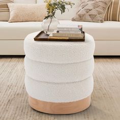 a living room with a white couch and a coffee table on top of the floor