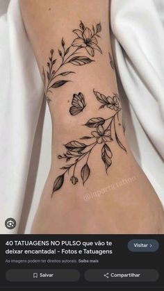 a woman's tattoo with flowers and leaves on the side of her leg, which is