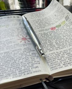 a pen sitting on top of an open book