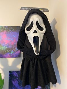 a scream mask hanging on the wall