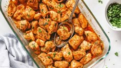 a casserole dish filled with chicken cubes and garnished with parsley