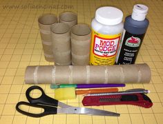 craft supplies laid out on top of a cutting board with scissors, glue, and other items