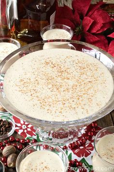 an image of a dessert in the middle of christmas decorations and nuts on the table