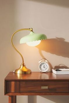 a desk lamp sitting on top of a wooden table