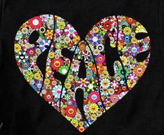 a black t - shirt with the word love spelled out in colorful flowers and hearts