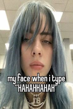 a girl with blue hair has her face close to the camera