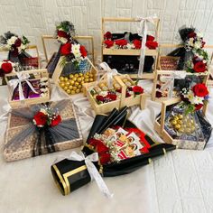 a table topped with boxes filled with lots of different types of food and flowers on top of it