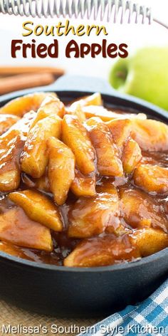 a close up of food in a pan on a table with apples and cinnamon sticks