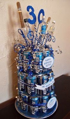 a birthday cake made out of cans and decorations