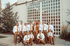 a group of men standing next to each other in front of a building