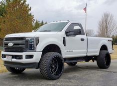 a white truck parked on top of a parking lot