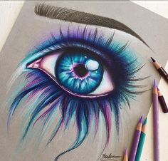 a drawing of an eye with colored pencils next to it