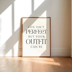 a framed poster with the words life isn't perfect but your outfit can be