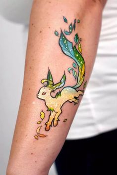 a woman's arm with a tattoo on it that has an image of a pokemon