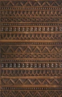 an intricately carved wooden panel with decorative designs on the sides and bottom, in dark brown