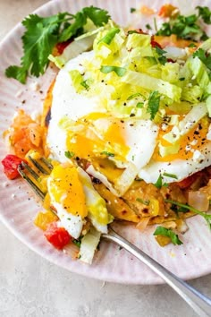 a plate with an egg and vegetables on it