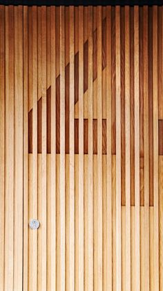 a close up of a wooden door with vertical slats