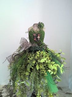 a mannequin made out of plants and foliage