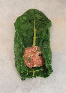 lettuce with meat in it on a white surface