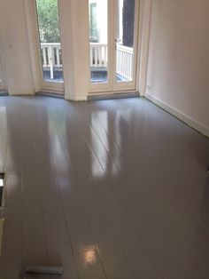 an empty room with sliding glass doors and hard wood flooring