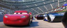 the cars are racing in front of an audience