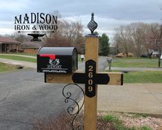 a mailbox with a cross on it in front of a house