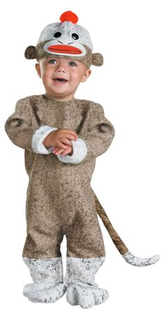 a little boy in a monkey costume standing with his hands on his hips and looking at the camera