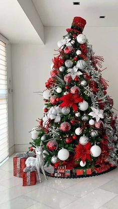 a christmas tree decorated with red, white and silver ornaments