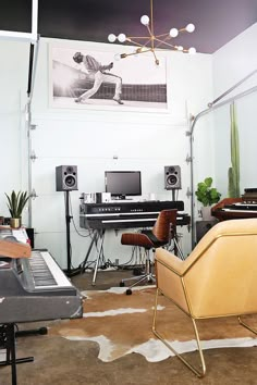 a living room filled with furniture and musical equipment