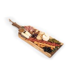 an assortment of meats and cheeses on a wooden platter with seasoning