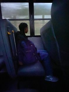 a person sitting on a bus in the dark