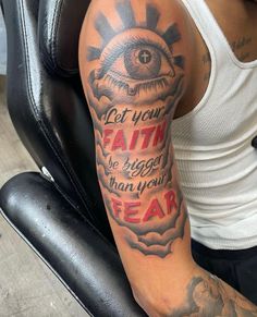 a man with a tattoo on his arm that says, let your faith be bigger than your fear