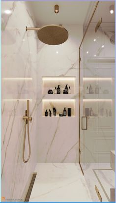 a bathroom with white marble walls and flooring, shower head, shelves on the wall